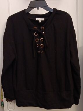 Socialite Black Pullover Top With Lace Up Neckline & Gold Eyelets.